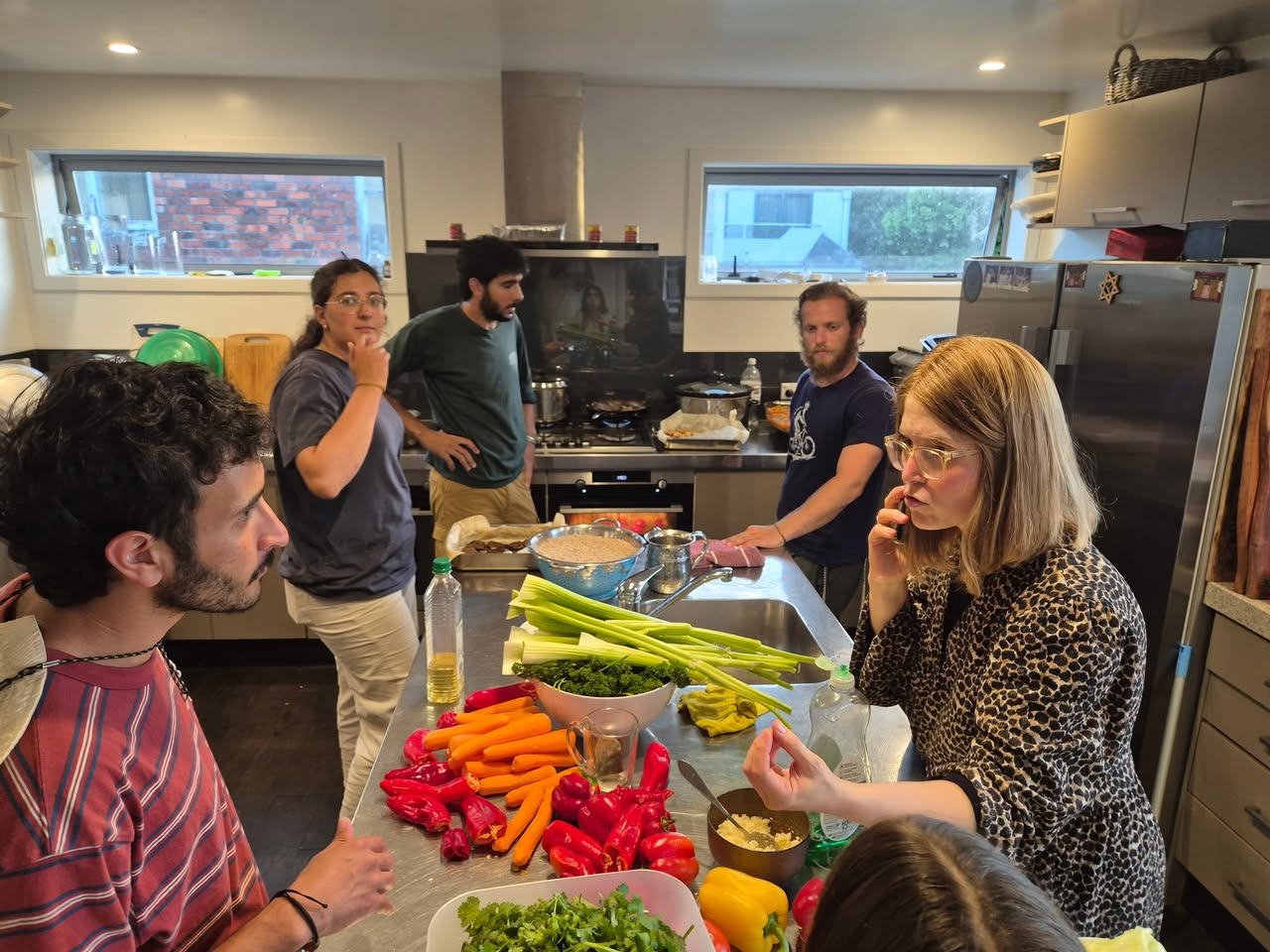 People preparing vegetables together around a kitchen bench at 788